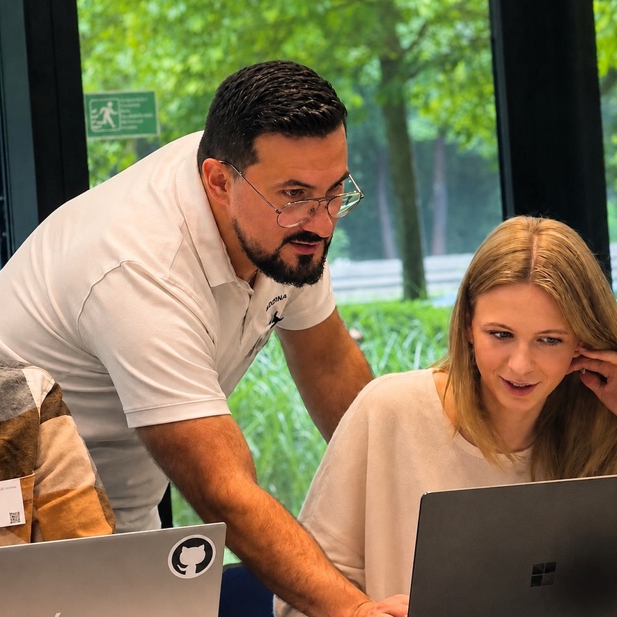Vedran Krizic working alongside a client team over a laptop during a workshop